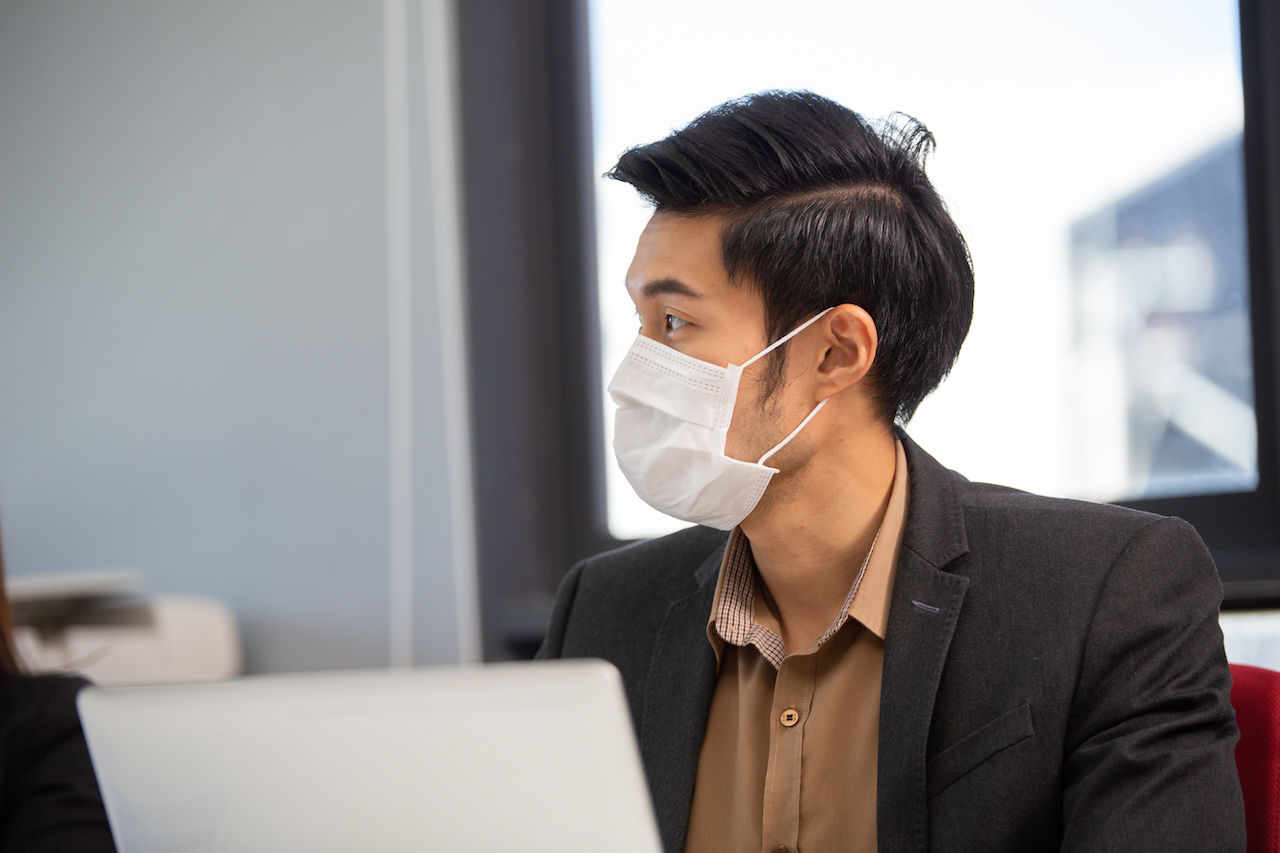 An asian employee listening to guidelines showing an Improved Compliance With Guidelines
