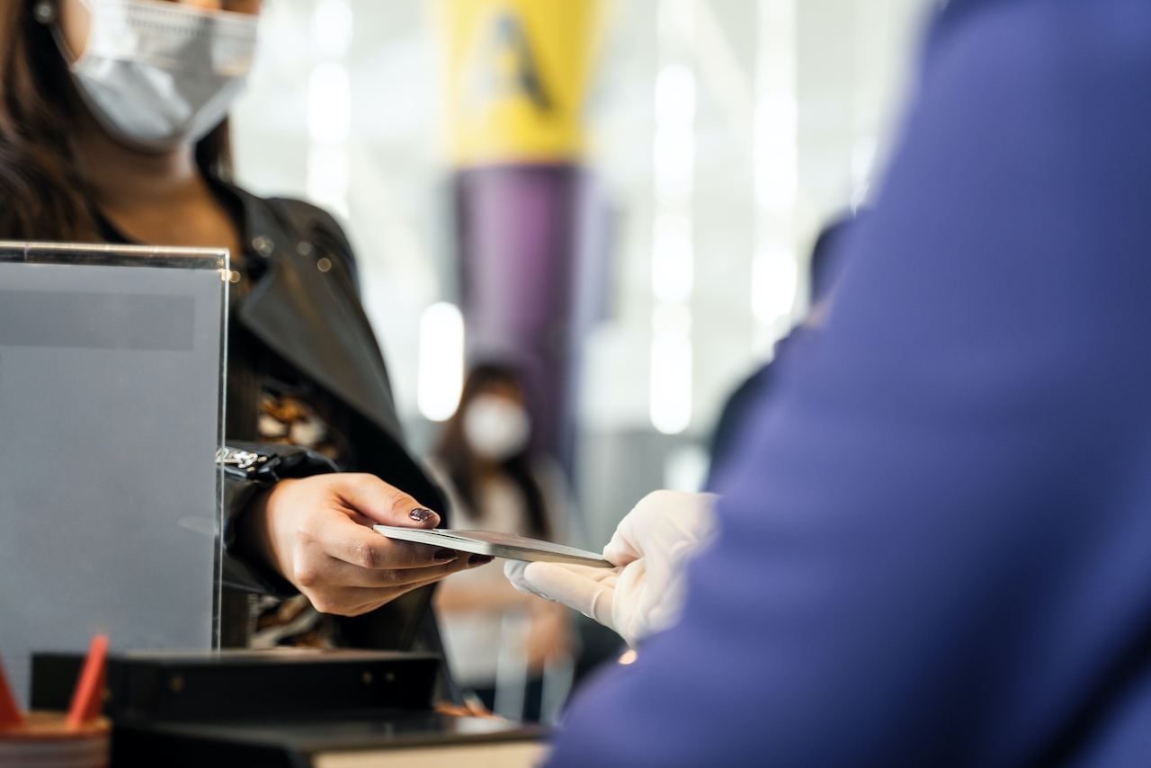 A woman checking in using an RFID card in a visitor management process.