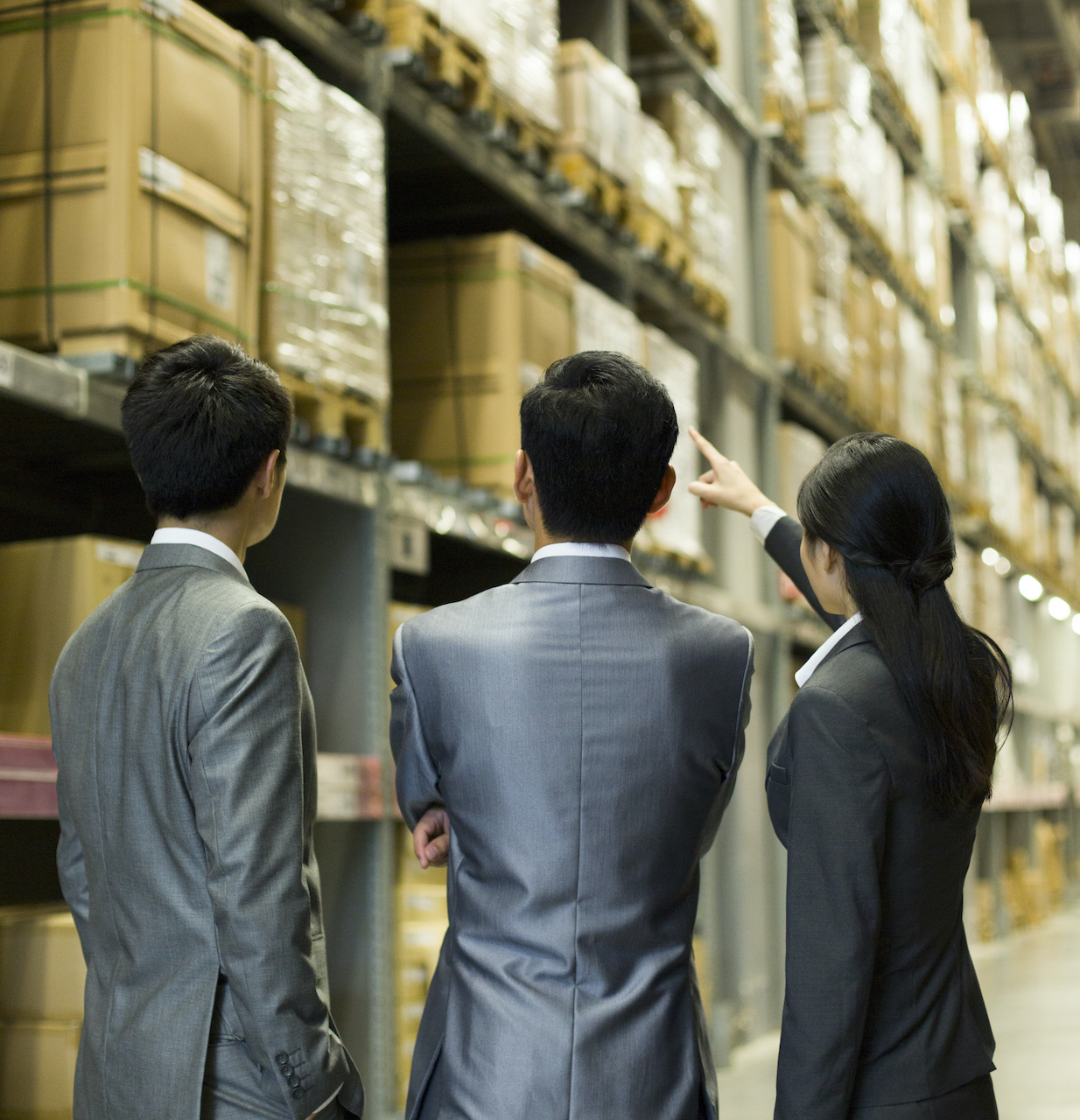 Improve Warehouse Efficiency. Chinese business people talking in warehouse