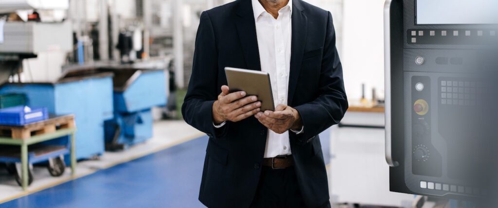 Manager using digital tablet in high tech company