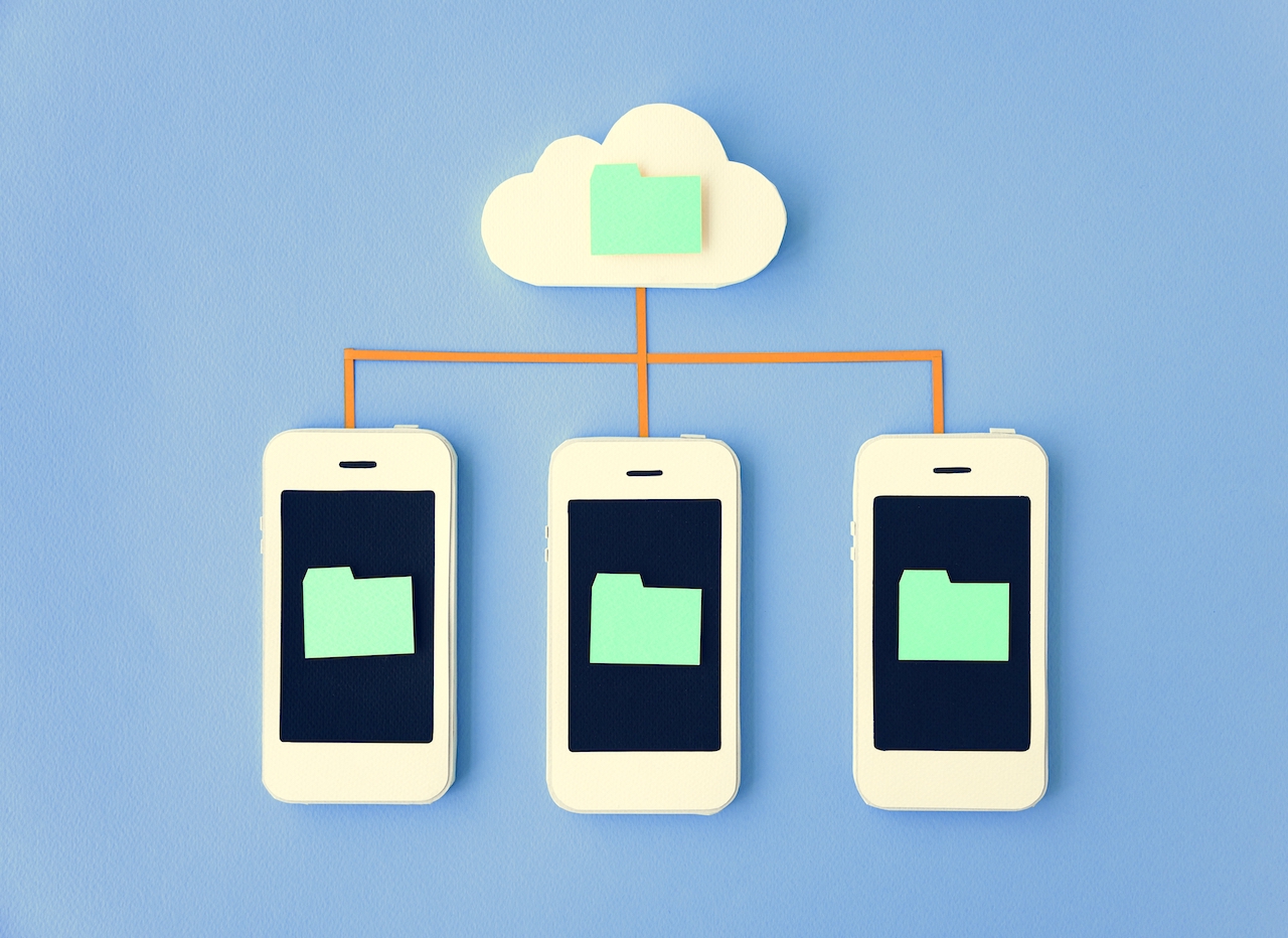 Three mobile phones showing connection to a cloud storage.