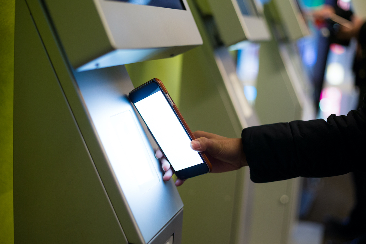 Checking in and scanning mobile phone on a visitor management kiosk