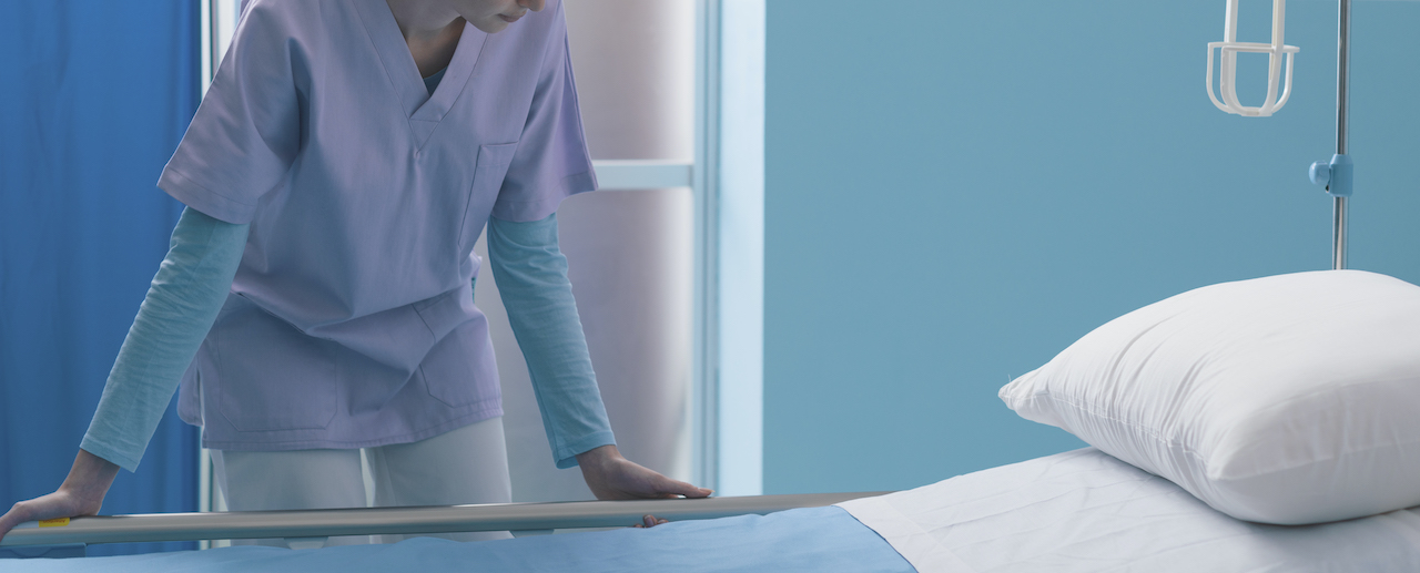 A nurse fixing up a hospital bed for asset tracking in hospital. 