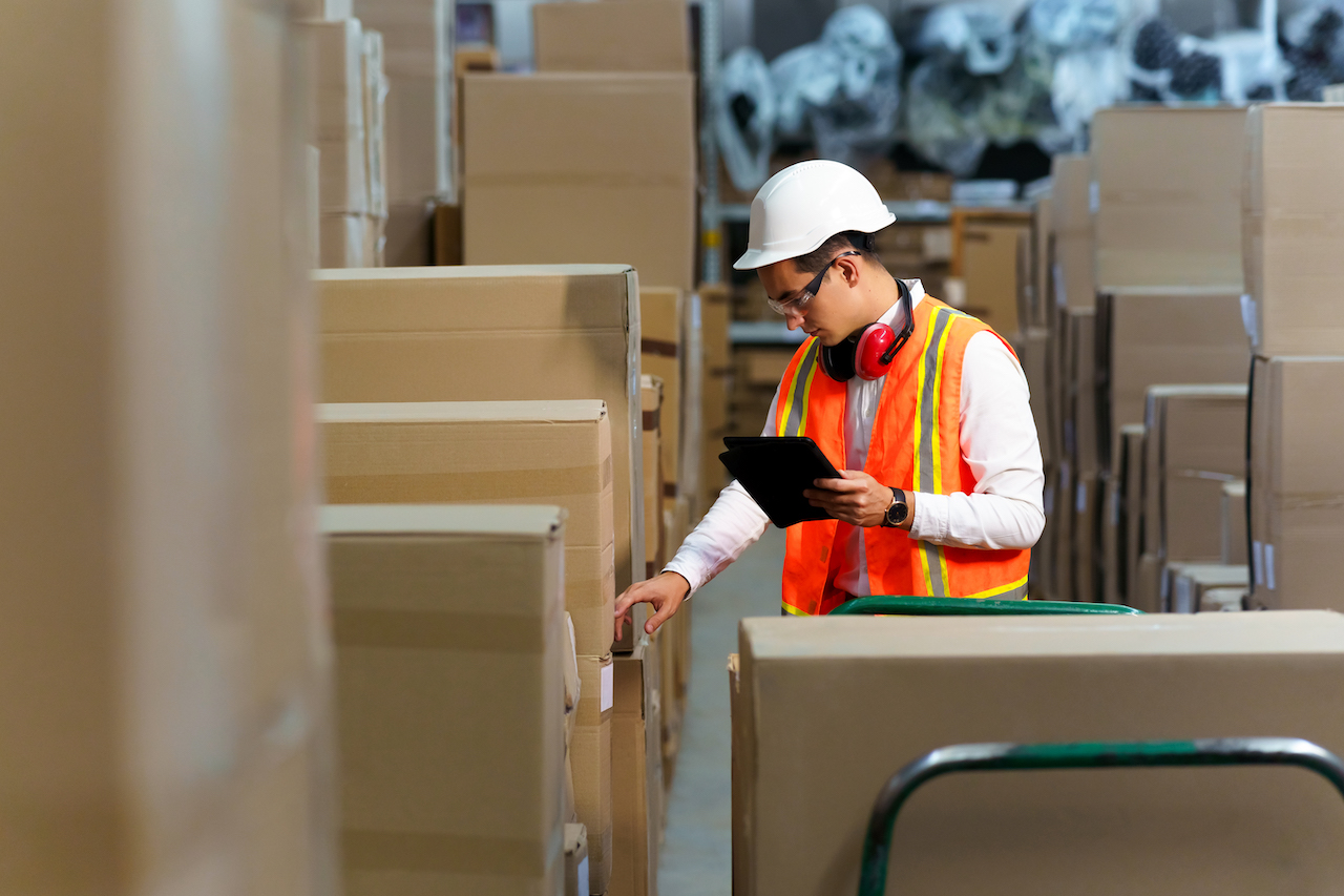 Employee of a logistics warehouse conducts an inventory of products