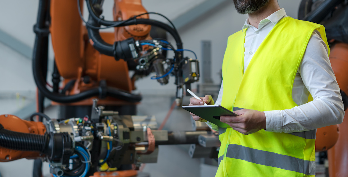 An automation engineer holding scanner in industrial in factory.