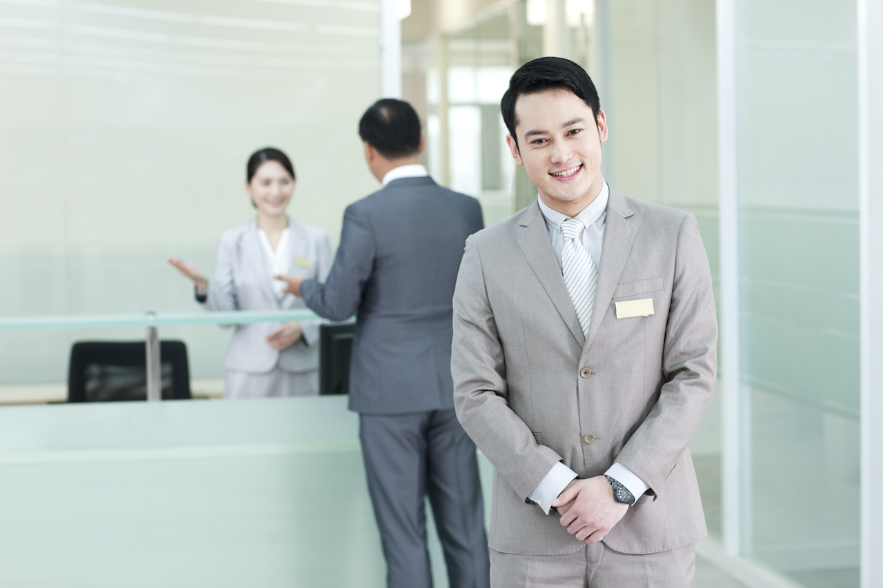 Chinese business persons at front desk