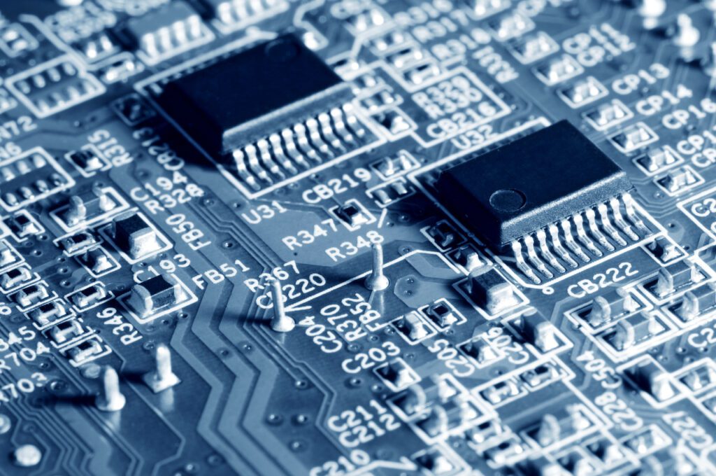 Close-up electronic circuit board with micro chips from a home appliance or laptop electronics and complex devices. Concept of microchips and future technology