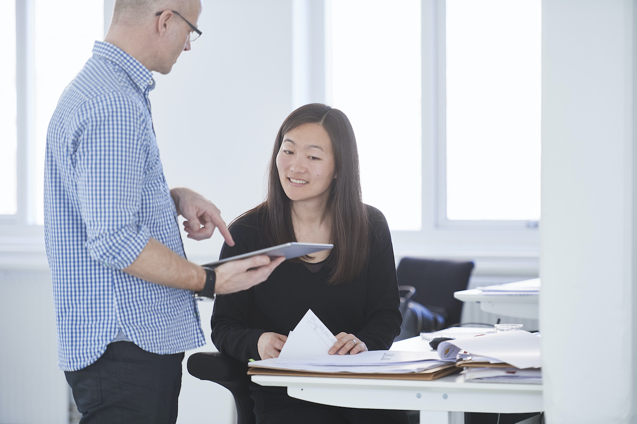 Colleagues in office using digital tablet