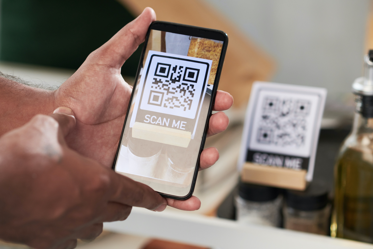 Close-up image of customer scanning a static QR code with smartphone.