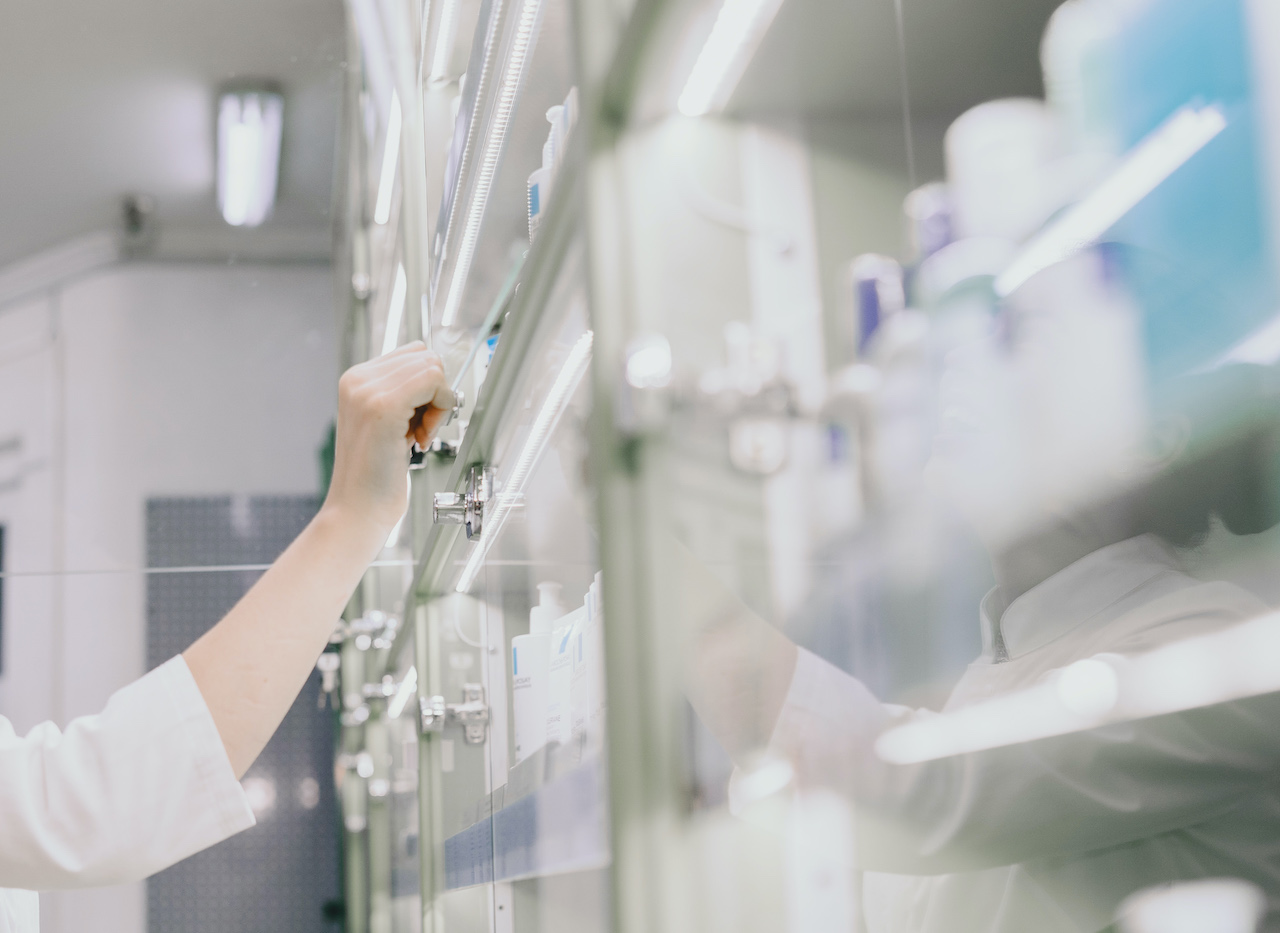 Medicine, pharmaceutics, health care and people concept. Female pharmacist taking medications from the shelf.