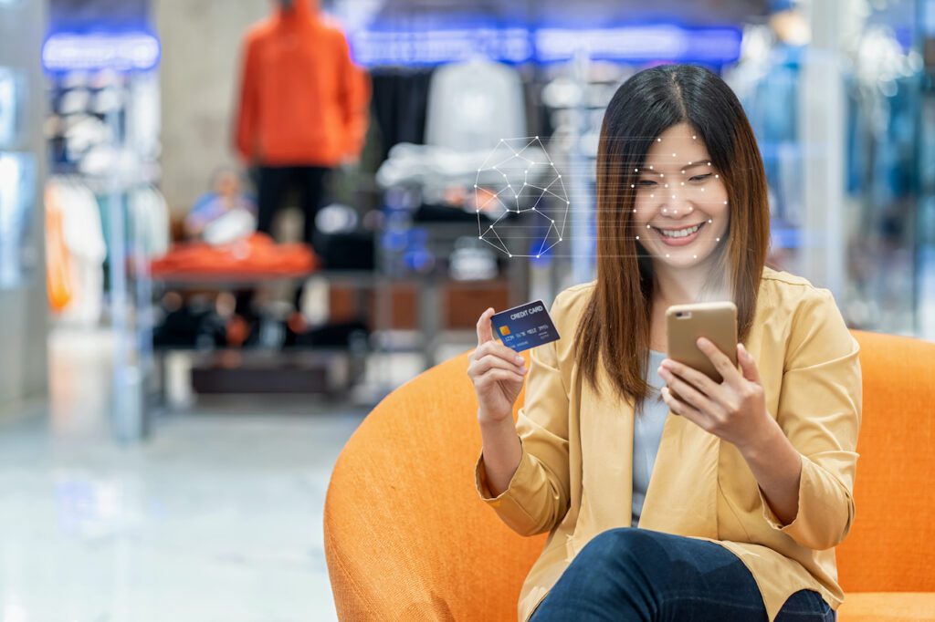 Asian women using the technology tablet for access control by face recognition in private identification step when online shopping with the credit card, credit card mockup, online payment concept,