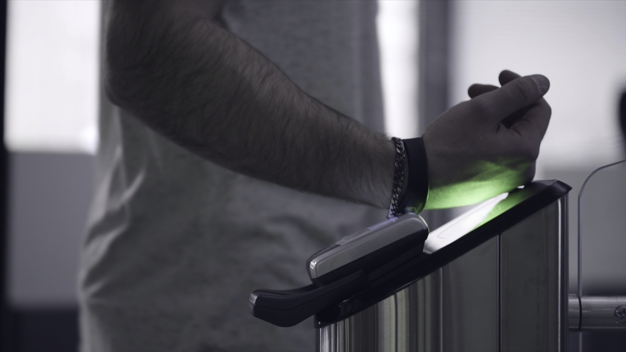 Turnstile Integration. Close-up view to turnstile. Frame. Electronic access control security system indoor side view. Close-up view of hand of man applying pass to turnstile.