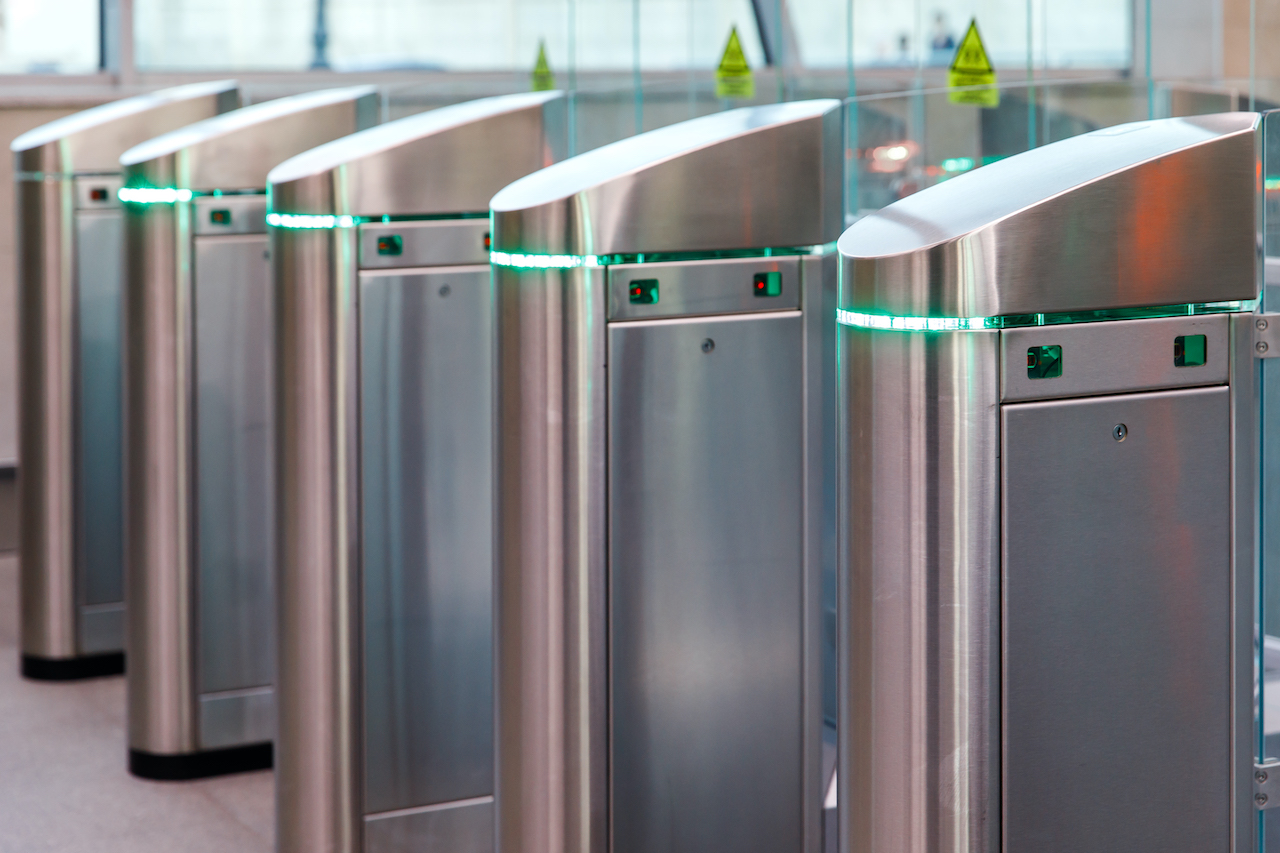 Turnstile Integration. Close up of modern turnstiles for the passage of subway trains transport/ railway station, inside. Entrance in metro with electronic card access.