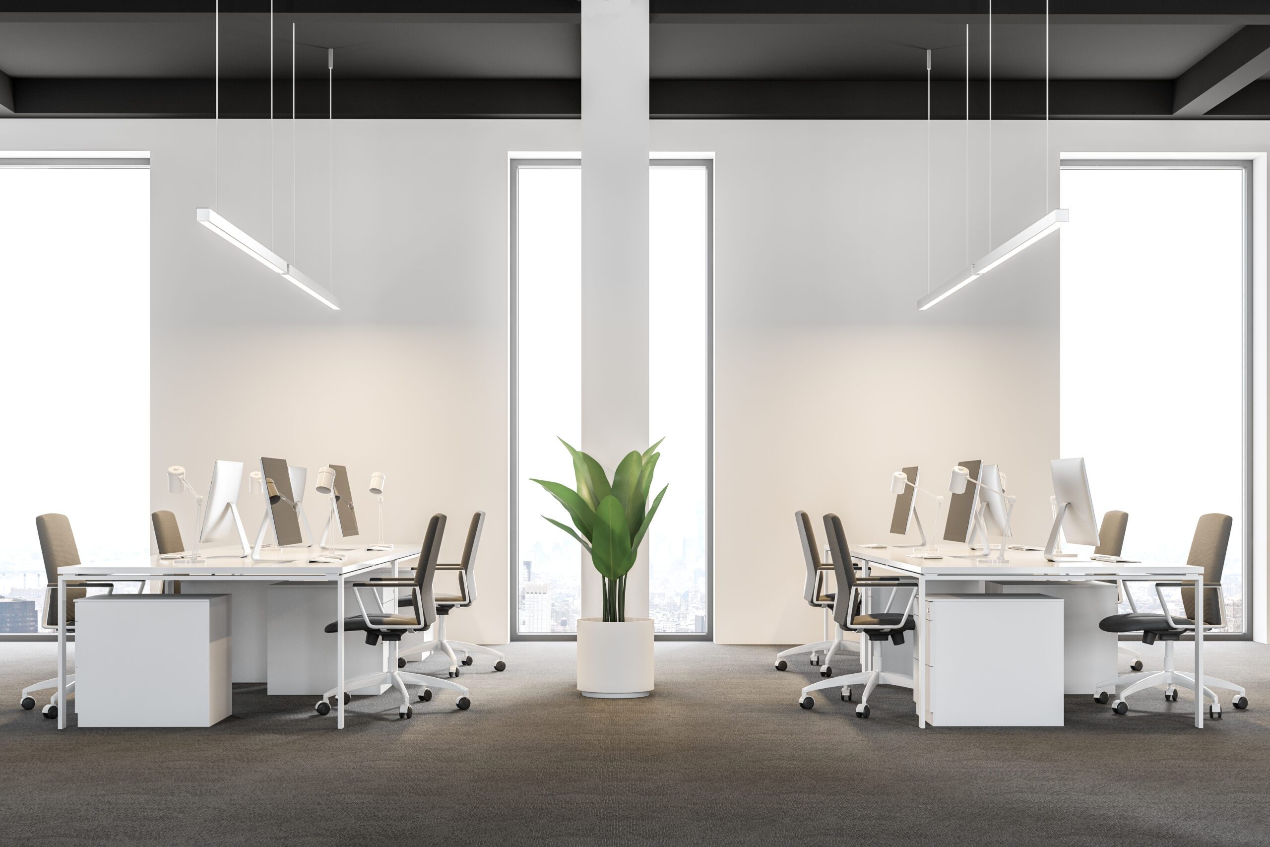 workspace with laptop computer in modern empty office with sunlight.  Facility Management System
